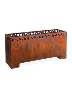 an old rusted metal planter with holes in the center and sides, on a white background