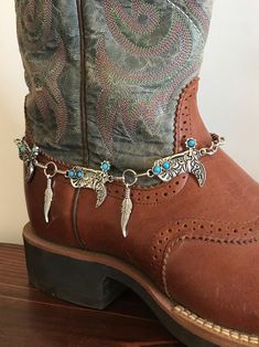 These are really adorable boot bracelets!  These are man made silver with silver boots with boho turquoise colored stones adorning the top of the boots and the spur. Faux silver feathers dangle in between the conchos. This boot bracelet  has Lobster clasp.   This is a Unique style not to be found anywhere but Old hands Creations! This one is 15" in total length. Check out our chain belts to complete your ensemble! Motorcycle Boot, Boot Chains, Length Check, Silver Boots, Boho Turquoise, Boot Bracelet, Turquoise Boho, Chain Belts, Old Hands