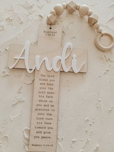 a wooden cross with the word andi on it