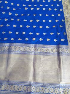 Drape six yards of pure elegance. This  brocade saree is a perfect festive wear. It is blue in color and is enhanced with multicolored floral motifs. Occasion: Partywear/Casual wear Material: pure silk Fabric: jamawar brocade Pattern: Floral/paisley/buti, motifs Border: Yes Border type: zari Zari Type: golden zari Length: 6.5mtr. Blouse: Yes Quantity :(1 pcs.) Blue Jamawar Pre-draped Saree With Zari Weaving, Blue Art Silk Pre-draped Saree With Traditional Patterns, Traditional Blue Pre-draped Saree With Self Design, Traditional Blue Pre-draped Saree For Festivals, Blue Wedding Pre-draped Saree With Zari Weaving, Blue Katan Silk Saree With Zari Work, Blue Katan Silk Saree With Zari Weaving, Blue Katan Silk Saree With Traditional Drape, Blue Katan Silk Saree In Traditional Drape