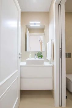 a bathroom with a sink, mirror and toilet