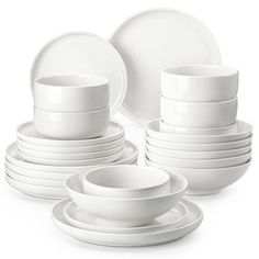 white dishes and cups are stacked on top of each other