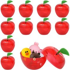 a bunch of red apples with some rubber toys in them and one has a yellow duck