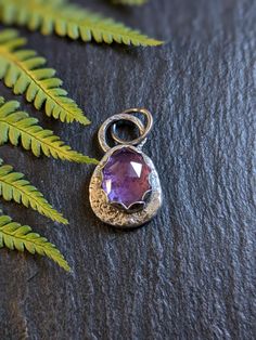 Recycled sterling silver chunky amethyst pebble pendant. I made this pendant using off cuts of sterling silver melted down and hammered flat. The shape is organic and freeform. The rose cut amethyst is set in a scalloped bezel with a hammered spot texture.  Oxidized to give a antique finish.  Measures 2.6cm  H 1.5 cm W The pendant is sold without a chain these can be purchased separately in my shop if needed. Nature-inspired Purple Sterling Silver Jewelry, Hand Forged Purple Pendant Necklace, Hand-forged Purple Pendant Necklace, Purple Sterling Silver Oval Pendant Necklace, Hand Forged Amethyst Pendant Necklace, Nature-inspired Silver Amethyst Jewelry, Silver Amethyst Oval Pendant Necklace, Unique Hand Forged Purple Necklaces, Silver Amethyst Necklace With Large Pendant