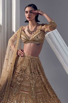 Light gold attached cancan lehenga floral sequin, bead embroidery all over. Paired with an embroidered padded blouse. Comes with a net dupatta with embroidered hem and scattered embroidery. - Aza Fashions Gold Pre-draped Saree With Intricate Embroidery For Reception, Gold Embellished Semi-stitched Lehenga, Semi-stitched Choli With Gold Embroidery For Reception, Gold Embellished Fitted Lehenga, Gold Embellished Choli For Festivals, Embellished Gold Choli For Festivals, Gold Embellished Kundan-inspired Choli, Festive Gold Embellished Lehenga, Gold Embellished Choli For Reception