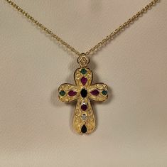 Byzantine style Greek Cross made of 18 carat solid yellow gold with genuine precious gemstones The Cross is decorated with different shapes Rubys,Sapphires,Emeralds and a Diamond 0.10 ct. Total weight of te colored stones is 3.20 ct. The specific Croos has been manufactured in one of the oldest jewelry workshops in Athens which is famous for production of byzantine jewelry It is a handmade Cross with spirals and grains Made in Greece inspaired by Byzantine art jewelry A beautiful piece of jewelr Gold Multi-stone Fine Jewelry Gemstones, Gold Multi-stone Gemstones In Fine Jewelry Style, Luxury Gold Multi-stone Gemstones, Gold Byzantine Jewelry With Multi-stone, Gold Byzantine Multi-stone Jewelry, Byzantine Multi-stone Jewelry As Gift, Gold Byzantine Jeweled Jewelry, Byzantine Jeweled Gold Jewelry, Byzantine Style Jeweled Gold Jewelry