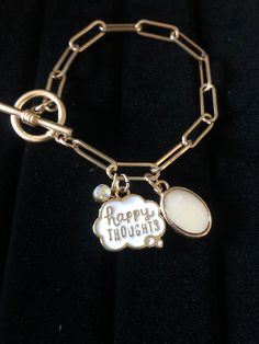 "\"Happy Thoughts\" Charm Toggle Bracelet!  Beautiful paperclip style, matte gold finish bracelet with toggle closure and 3 charms.  Makes a beautiful gift or a nice mantra for yourself to live by! Link chain bracelet is made of metal with linked flat oval pieces for that paperclip look. Each link has a bright and shiny color and matte finish. Bracelet measures 7.25\". Includes three charms: *White enamel cloud-shaped charm outlined in gold with gold font in the cloud that reads \"happy THOUGHTS\"--so cute! *A white oval shaped mother-of-pearl flat charm in a gold setting *A mini faceted round, iridescent rhinestone charm in a gold setting   Comes beautifully boxed and ready for gift giving (no price on ticket, just sku)" Motivational Bracelets, Mantra Bracelet, Positive Encouragement, Toggle Bracelet, Gold Set, Happy Thoughts, White Enamel, Matte Gold, Paper Clip