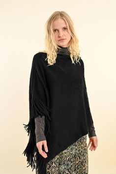 Upgrade your wardrobe with our Fringe Poncho in classic black. Made with soft material, this poncho is both comfortable and stylish. The fringe detail adds a touch of texture, making it the perfect addition to any outfit. Elevate your look and stay cozy with our Fringe Poncho - Black. Cozy Winter Poncho With Fringe, Chic Black Poncho For Layering, Chic Black One-size Poncho, Chic One Size Black Poncho, Black Winter Poncho For Layering, Short Poncho, Fringed Poncho, Short Fringe, Estilo Chic