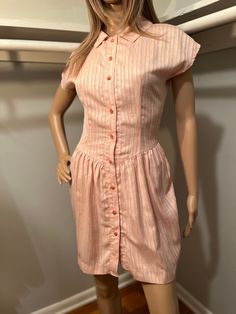 "Vintage pink dress. Buttons up front. Best for an XS/XXS. Length 33\" Best for 24-25\" waist  Pit to pit 17\" All measurements of items listed are approximate, and are taken as accurately as I can to the best of my ability. Please note that with vintage items, there may be signs of wear and small imperfections. When possible, we will show imperfections and the price will reflect these. If you have any questions, or would like to see more pictures, please don't hesitate to reach out." Fitted Casual Dress For Vintage Fashion, Pink Mini Vintage Dress For Spring, Pink Vintage Mini Dress With Short Sleeves, Pink Fitted Casual Vintage Dress, Pink Dress With Fitted Waist And Short Sleeves, Pink Mini Length Vintage Dress For Summer, Pink Mini Vintage Dress For Summer, Vintage Pink Mini Length Dress, Casual Pink Vintage Dress With Short Sleeves