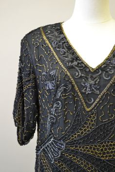 "Description: 1980s black sequin and bead blouse. Some of the sequins have a matte finish. Scalloped edge on hem and sleeve cuffs. Padded shoulders and a V-neck. Silk exterior with rayon lining. Made in India. Condition: In great condition, with no holes or stains. Designer: Mark and John II Stated Size: Large Measurements: Armpit to armpit: 20\" Shoulder to shoulder: 19\" Sleeve length: 14\" Overall length: 24\" Waist: 38\" ---> If you need an order shipped by a particular date or shipped vi Vintage V-neck Blouse For Party, Vintage V-neck Party Blouse, Vintage V-neck Blouse For Evening, Formal V-neck Top With Sequins, Fitted Beaded V-neck Blouse, Formal V-neck Sequin Tops, V-neck Beaded Blouse For Party, Beaded V-neck Tops For Evening, Sequin Blouse