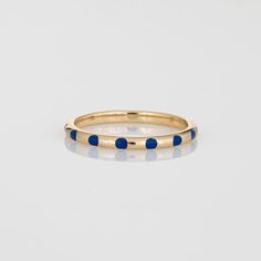 Stylish blue polka dot enamel & diamond stacking band crafted in 14 karat yellow gold.   1 round brilliant diamond is estimated 0.02 carats (estimated at H-I colour and SI2 clarity).   The enamelled polka dot band is set with a small diamond. The low rise ring (2mm - 0.07 inches) sits comfortably on the finger. Great worn alone or stacked with your fine jewellery from any era.   The ring is in very good condition.   Particulars:  Weight: 1.7 grammes  Stones:  1 round brilliant diamond is estimat Modern 14k Gold Enamel Round Ring, Modern Round Enamel Ring In 14k Gold, Blue Enamel Ring With Polished Finish, Blue Enamel Polished Round Ring, Blue Polished Enamel Ring, Yellow Gold Stackable Enamel Rings, Yellow Gold Polished Enamel Ring, Polished Yellow Gold Enamel Ring, Yellow Gold Round Enamel Ring With Polished Finish