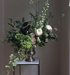 a vase filled with flowers sitting on top of a table