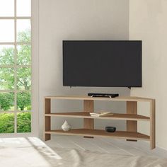 a flat screen tv sitting on top of a wooden entertainment center next to a window