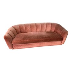 a pink couch sitting on top of a white floor