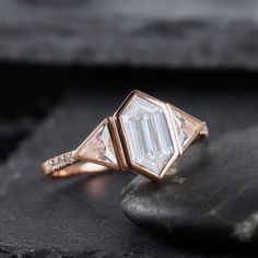 a diamond ring sitting on top of a rock