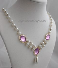 This exquisite Renaissance-style necklace is a timeless classic. Featuring 14x 10mm acrylic gems and 6mm creamy white glass pearls, this dainty piece will add a hint of luxury to any Renaissance and Victorian look. The Irina necklace will add a subtle touch of elegance to any garb ensemble. Necklace length is 17-18", with a 2-3" extender attached. Longer and shorter lengths available upon request, message me with your desired length. Gold Amethyst Necklace For Wedding, Wedding Gold Necklace With Amethyst, Classic Amethyst Necklaces For Wedding, Classic Gold Necklace With Faceted Beads, Purple Pearl Formal Jewelry, Purple Pearl Jewelry For Formal Occasions, Formal Purple Pearl Jewelry, Elegant Amethyst Jeweled Necklaces, Elegant Purple Pearl Necklace For Formal Occasions