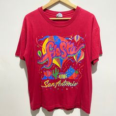 "Vintage 90s San Antonio Texas Large T-Shirt Single Stitch Made in USA 1990s retro single stitch rainbow Fiesta festival top! Raspberry red + multicoloured cute print - hot air balloons, rainbows, stars, cactus, chili & cowboy boots!  Made in USA - stitched in All Season tag.  American novelty tourist souvenir shirt from the annual San Antonio Fiesta event - dating back to 1891. 100% cotton  - heavyweight material, super comfy & wearable.  Short sleeves, ribbed crew neck, relaxed boxy fit.  Pit to pit: 22\". Recommended fit guide: - Men's: Fitted Large or Medium if worn baggy / oversized. - Women's: As above / up to a fitted UK 18.  See all measurements below.  In good vintage condition for age - cracking to the print, as pictured & reflected in price.  Measurements: Length: 25\" Chest cir Vintage Multicolor Screen Print T-shirt, Vintage Multicolor T-shirt With Letter Print, Retro Rainbow T-shirt For Summer, Red Retro Top With Graphic Print, Retro Multicolor Print Summer T-shirt, Summer Rainbow Graphic Print Tops, Y2k Style Multicolor Short Sleeve T-shirt, Rainbow Graphic Print Top For Summer, Rainbow Graphic Print Tops For Summer