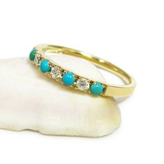 Handmade from 14 karats yellow gold, this stacking ring features seven rounded gemstones alternating between 0.1-carat diamonds and bright blue turquoise.  #jonjonjewel #turquoisejewelry #weddingring Turquoise Diamond Rings With Gemstones, Fine Jewelry Turquoise Multi-stone Ring, Stackable Turquoise Ring In Fine Jewelry Style, Stackable Turquoise Ring Fine Jewelry, Turquoise Diamond Rings Fine Jewelry, Turquoise Multi-stone Ring Fine Jewelry, Turquoise Diamond Ring As A Gift, Turquoise Diamond Ring As Gift, Turquoise Diamond Ring With Diamond Accents As Gift