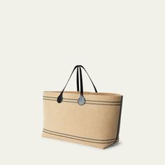 Loro Piana "Tasman" canvas tote bag in cotton and polyester  Two carry handles  Logo charms  Wipe clean Lining: Cotton Trim: Leather Made in Italy Loro Piana, Canvas Tote Bag, Bergdorf Goodman, Canvas Tote, Tops Designs, Handles, In Italy, Charms, Trim