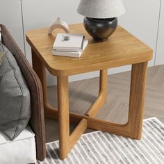 a wooden table with a lamp on it next to a chair and pillow in a room