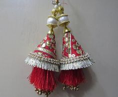 Red And Golden Fabric Gota Patti and Pearl Beaded Traditional Indian Bridal Lehenga Tassels | Ethnic Sewing Tassel Latkan For Indian SareeHandmade Hanging/tasselsMaterial:Silk, Thread, Motifs, Gota PattiPackage Contents: 4Key Features:Embroidery art workThis  is good match with both Indian Bridal Lehenga outfits and are superb for wedding and festive parties.This would be best complement to your designer saree, lenhga or any other kind of dress.This is the combination of traditional and modern e Multicolor Anarkali Dupatta With Tassels, Multicolor Traditional Wear With Tassels, Traditional Festive Choli With Tassels, Multicolor Bollywood Traditional Wear With Tassels, Bohemian Choli With Tassels For Diwali, Bollywood Style Multicolor Traditional Wear With Tassels, Traditional Red Lehenga For Festival, Bohemian Embroidered Red Lehenga, Red Wedding Traditional Wear With Latkans