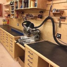 a workbench with many drawers and tools on it, including a grinder