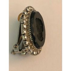 a black and silver ring with lots of stones