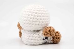 two crocheted stuffed animals sitting next to each other on a white table top