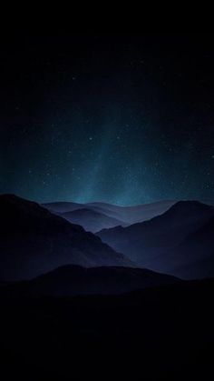 the night sky is lit up with stars above mountains and valleys in the foreground