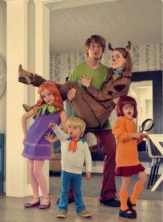 a group of people standing around each other wearing costumes that look like characters from the movie scooby