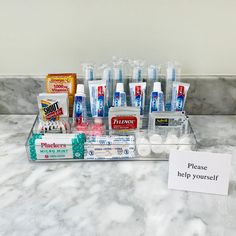 a counter with toothpaste and other dental care products on it's tray