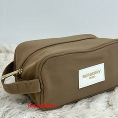 Burberry Hero Pouch Dopp Kit Shaving Case Toiletries Bag Travel Logo Beige New Brand New Gorgeous Beige/Gold Color Pouch For Cosmetics, Toiletries Or Any Personal Care. Excellent For Travel And Daily Use. Fully Lined With Small Interior Pocket. Black Large Burberry Logo Up Font And Embossed Logo On Carry Handle. Beige Color, But Very Bright, Almost Gold. With Black Burberry Logo On The Front. 100% Authentic, Made Exclusively For The Burberry Fragrance Collection. Approx Dimensions: 4" X 10" X 3" Pet And Smoke Free Home In Order To Run An Environmentally Friendly Store I May Reuse Boxes And Packaging Materials. Please Feel Free To Ask Any Questions You May Have, I Respond To Questions Burberry Hero, Burberry Fragrance, Logo Beige, Leather Zip Pouch, Burberry Logo, Grooming Bag, Travel Logo, Dopp Kit, Leather Clutch Bags