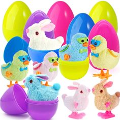 there are many stuffed animals in an egg holder with easter eggs behind them and on the ground