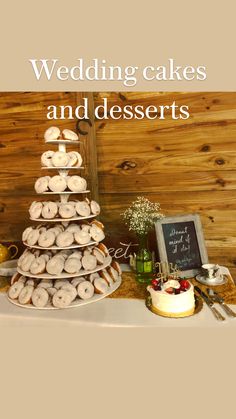 a table topped with three tiered trays filled with donuts next to a cake