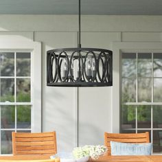 a dining room table with chairs and a chandelier hanging from the ceiling