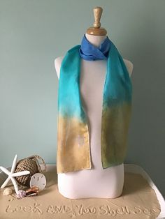 "Colorful, beautiful, and lightweight 100% silk scarf inspired by the sea.  Perfect for all seasons.  Blue, turquoise, and sand colored silk scarf depicting baby sea turtles returning to the sea! A beautiful art piece you can WEAR! We have 5 scarves in stock, so colors and design may vary. If you would like a specific variation, please send us a message and we'll do our best to match you with the perfect scarf! 8\" wide by 72\" long  Hand wash in cold water with a mild detergent.  Highest grade Australian dyes chemically bond with the silk during the steaming process leaving the scarf soft and supple with brilliant vivid colors." Blue Summer Scarves For Vacation, Silk Scarves For Beach In Summer, Silk Scarves For Summer Beach, Handmade Summer Beach Scarves, Summer Blue Silk Scarf, Hand Dyed Blue Silk Scarf For Summer, Summer Hand Dyed Blue Silk Scarf, Blue Hand-dyed Silk Scarf For Summer, Blue Hand Dyed Silk Scarf For Summer