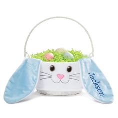 a white basket filled with green grass and an easter bunny