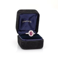 This is part of Chairish’s Fine Jewelry assortment.  Vintage Tiffany & Co ruby & diamond cluster ring crafted in 900 platinum (circa 1960s).    Oval mixed cut natural ruby measures 7.1 x 5.4 x 3.0mm (estimated at 1 carat). Color and inclusions are typical of rubies from Burma (Myanmar). There is no evidence of any treatments to the ruby. Sixteen diamonds total an estimated 0.70 carats (estimated at F-G color and VS clarity). The ruby is in good condition with two tiny chips evident (visible unde Luxury Ruby Cluster Ring With Center Stone, Luxury Cluster Ruby Ring With Center Stone, Classic Cluster Ruby Ring With Center Stone, Classic Ruby Cluster Ring With Center Stone, Formal Cluster Ruby Ring, Classic Cluster Ruby Ring, Luxury Ruby Ring Marquise Cut For Formal Events, Luxury Ruby Marquise Cut Ring For Formal Occasions, Luxury Marquise Cut Ruby Ring For Formal Occasions