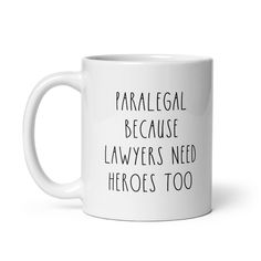 a white coffee mug with the words paralegge because lawyers need hero's too