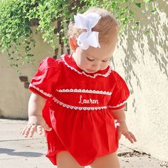 Your little one will look simply enchanting in our Lace Trim Red Lily Bubble, perfect for celebrating the holiday season in style! With its ruffle collar, delicate lace trim, and sweet bishop sleeves, this festive red bubble is ideal for Christmas gatherings and holiday photos. Snaps at the stride make changes easy. Add a monogram to make it even more special and uniquely hers, bringing a personalized touch to the holiday magic! Red Lily, Christmas Gathering, Girl's Back, Christmas Pjs, Red Embroidery, Bubble Dress, Holiday Magic, Red Bubble, Ruffle Collar