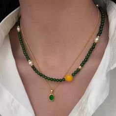 This double-strand necklace is an eye-catching blend of elegance and boldness, featuring green jade beads with golden accents, complemented by striking yellow gemstone spheres and freshwater pearls. The high-quality gold-plated brass ensures durability while enhancing the luxurious appearance. Ideal for both formal and casual occasions, this necklace is sure to elevate any outfit with its rich colors and refined design. Details Material: 24K gold-plated brass, green jade, freshwater pearls, and Chrysoprase Necklace, Double Strand Necklace, Yellow Gemstones, Stone Beaded Necklace, Pearl Jewelry Necklace, Natural Stones Necklace, Gold Statement Earrings, Natural Stone Jewelry, Natural Stone Bracelets