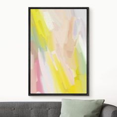 an abstract painting hangs on the wall above a couch in a living room with pillows