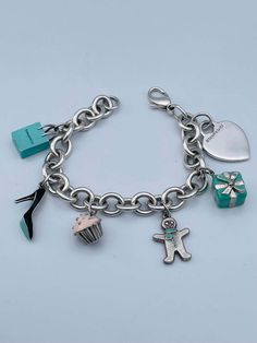 For Sale on 1stDibs - Charming charm bracelet. Made and signed by TIFFANY & CO. Sterling silver bracelet, with a sterling heart charm and five enamel figural charms: a Tiffany Tiffany And Co Charm Bracelet, Luxury Removable Charms For Gifts, Designer Enamel Jewelry For Gift, Designer Enamel Jewelry As A Gift, Luxury Logo Charm Bracelet As Gift, Luxury Charm Bracelet With Logo Charm As Gift, Luxury Charm Bracelet As Gift, Luxury Charm Bracelet For Gift, Luxury Charm Bracelet - Perfect Gift