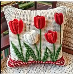 a white pillow with red flowers on it