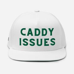 a white hat with the words caddy issues printed on it, and green lettering