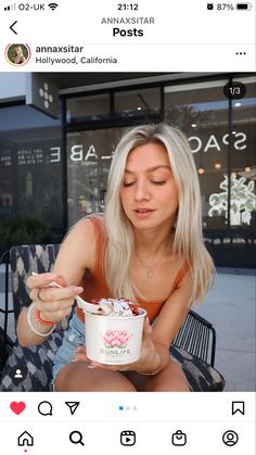 a woman sitting on a chair holding a cup of ice cream in her right hand