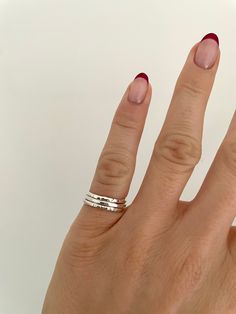 Dainty Pinky Ring Stacking Set | Recycled Sterling 925 Silver | Handmade Sterling Silver Stacking Ring Set | Hammered Solid Silver Ring | Stackable Rings | Silver Pinky Ring | Pinky Ring Woman This stacking ring set consists of three pinky rings handmade from recycled sterling silver. Each ring is 1.5mm wide and has a different texture/finish.  Handmade from 100% recycled sterling (925/solid) silver.  Recyclable packaging.  This set of rings are also available to purchase in larger sizes (link below)  https://www.etsy.com/uk/listing/1391528620/3-x-15mm-recycled-sterling-silver?click_key=8eaf5cd2e2b8b53c834510481d4cf6d0efb3d7a1%3A1391528620&click_sum=1de6e709&ref=shop_home_active_26&frs=1&sts=1 All orders include a personalised thank you note. If you would like to send as a gift with a gift Silver Pinkie Ring, Rings Inspo Silver, Ring Stacks Silver, Silver Ring Stack, Silver Pinky Ring, Pinky Rings, Multi Ring, Hand Rings, Stackable Rings Silver