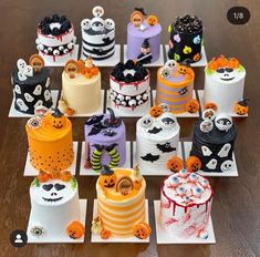 there are many different cakes on the table together, all decorated with halloween decorations and pumpkins