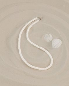 "This choker necklace features quality white shell heishi beads.  The literal meaning of heishi (pronounced hee-shee) is \"shell\" and these beads are made using pieces of oyster shell (also known as mother-of-pearl) made into flat beads. A string of good heishi will have a uniform consistency in bead size and if you gently pull it through your hand, it should feel like a single serpent-like piece.  When you look closely at each bead, you see the amazing detail and unique coloration of each bead White Heishi Beads Single Strand Necklace, White Single Strand Heishi Beads Necklace, Beach Jewelry With White Letter Beads, White Heishi Beads Single Strand Jewelry, White Letter Beads Jewelry For Beach, White Beach Jewelry With Letter Beads, White Jewelry With Letter Beads For Vacation, White Shell Necklace, Adjustable, White Strand Shell Necklace As Gift