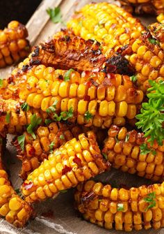 grilled corn on the cob with garnish and parsley sprig